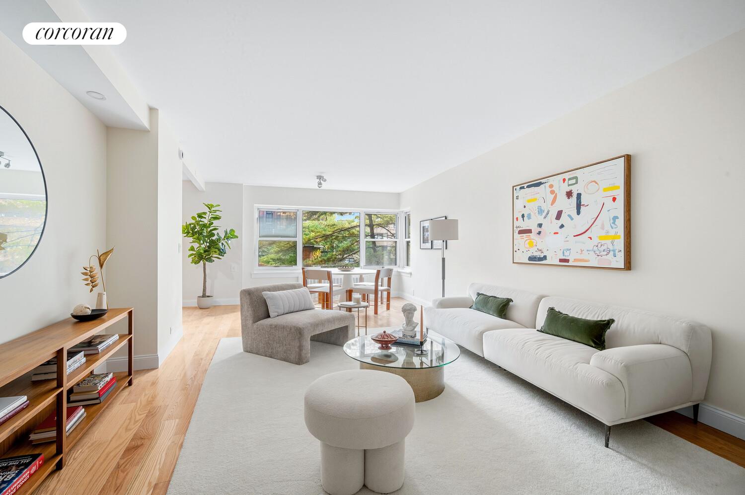 430 East 56th Street, Unit 3A Manhattan, NY 10022 - Photo 2 of 8 a living room with furniture and a large window