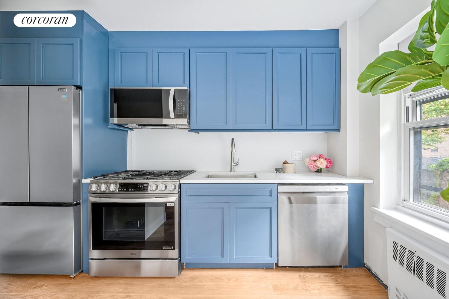 430 East 56th Street, Unit 3A Manhattan, NY 10022 - Photo 4 of 8 a kitchen with a stove and a microwave