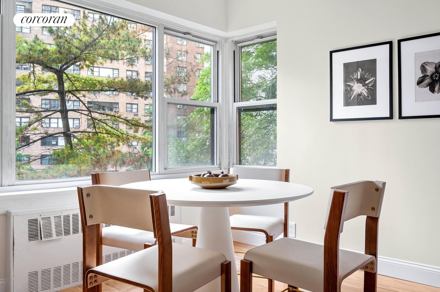 430 East 56th Street, Unit 3A Manhattan, NY 10022 - Photo 6 of 8 a view of a dining room with furniture window and outside view