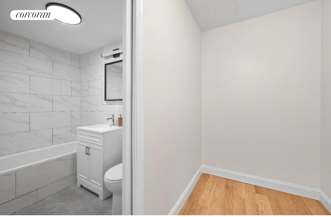 430 East 56th Street, Unit 3A Manhattan, NY 10022 - Photo 7 of 8 a bathroom with a toilet a sink and bathtub