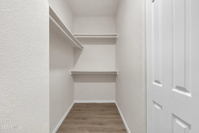 a view of a livingroom with wooden floor and stairs