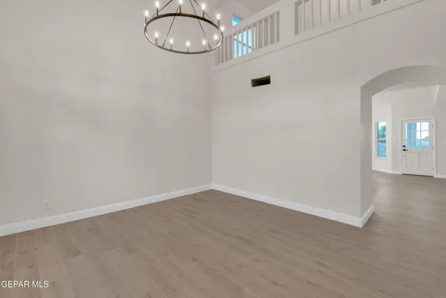 a view of a room with wooden floor and glass door