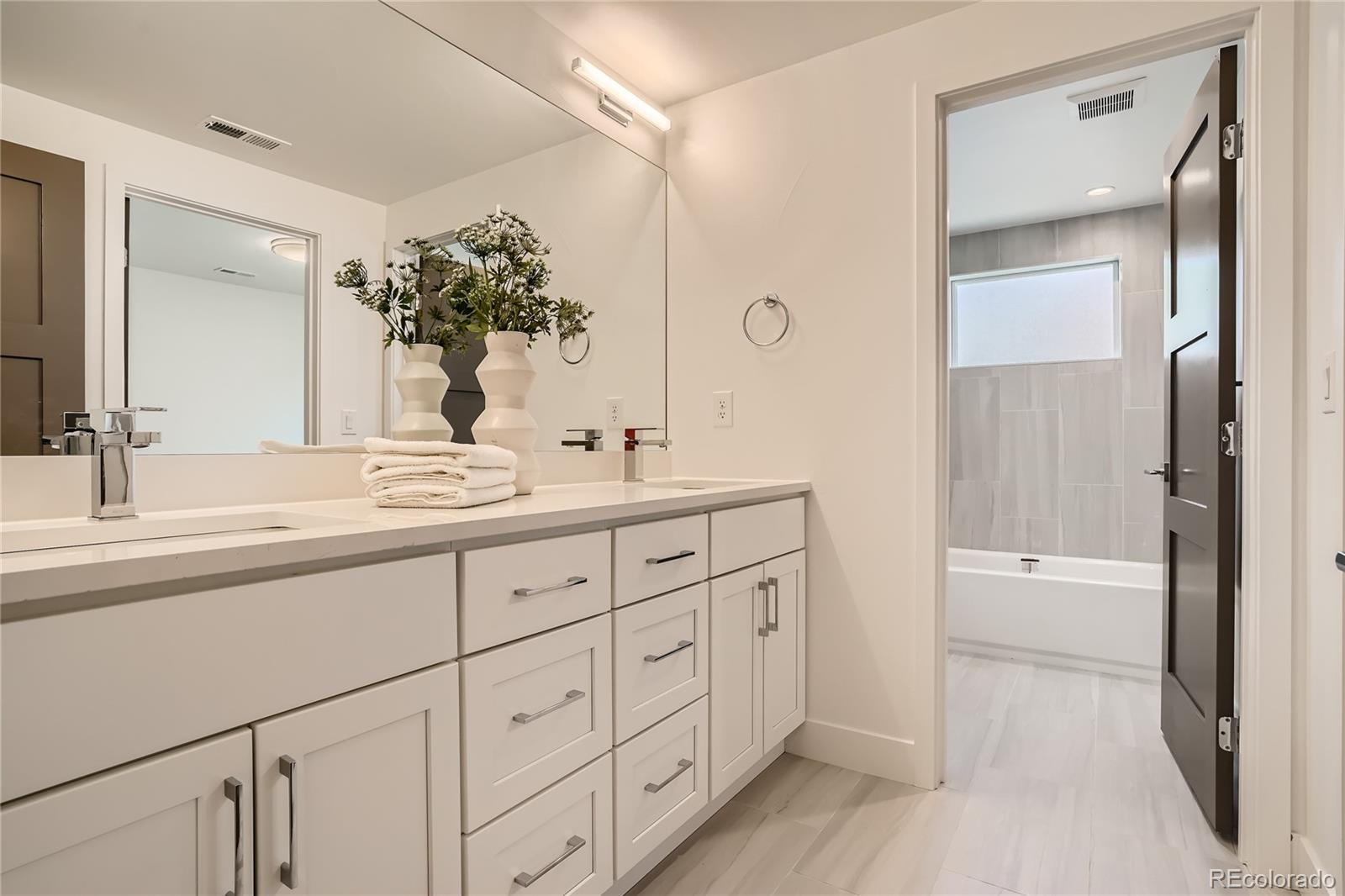 1255 Perry Street Denver, CO 80204 - Photo 12 of 28 a bathroom with a double vanity sink and a mirror