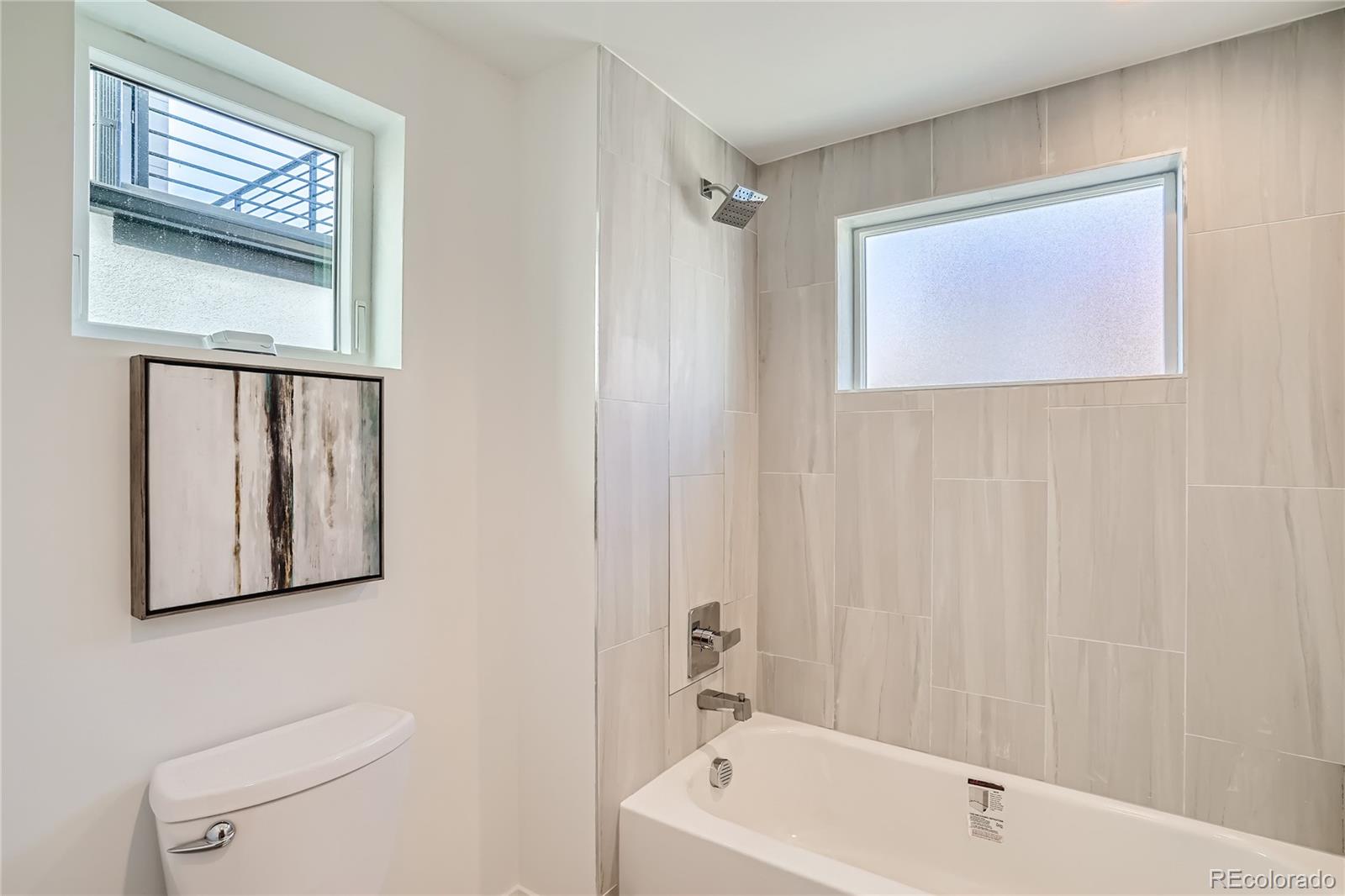 1255 Perry Street Denver, CO 80204 - Photo 13 of 28 a bathroom with a toilet a sink and a bathtub