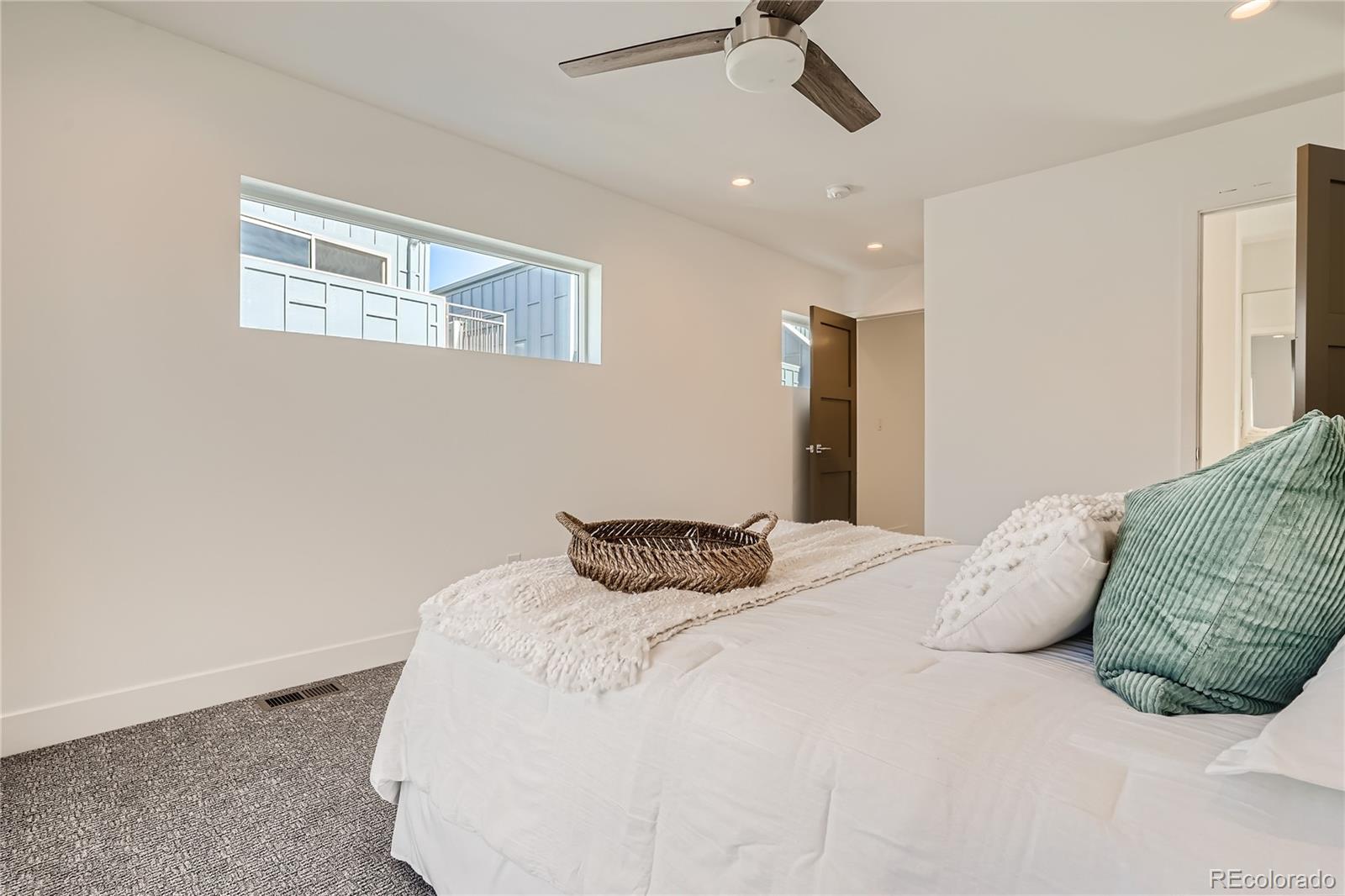 1255 Perry Street Denver, CO 80204 - Photo 17 of 28 a bedroom with a bed and a window