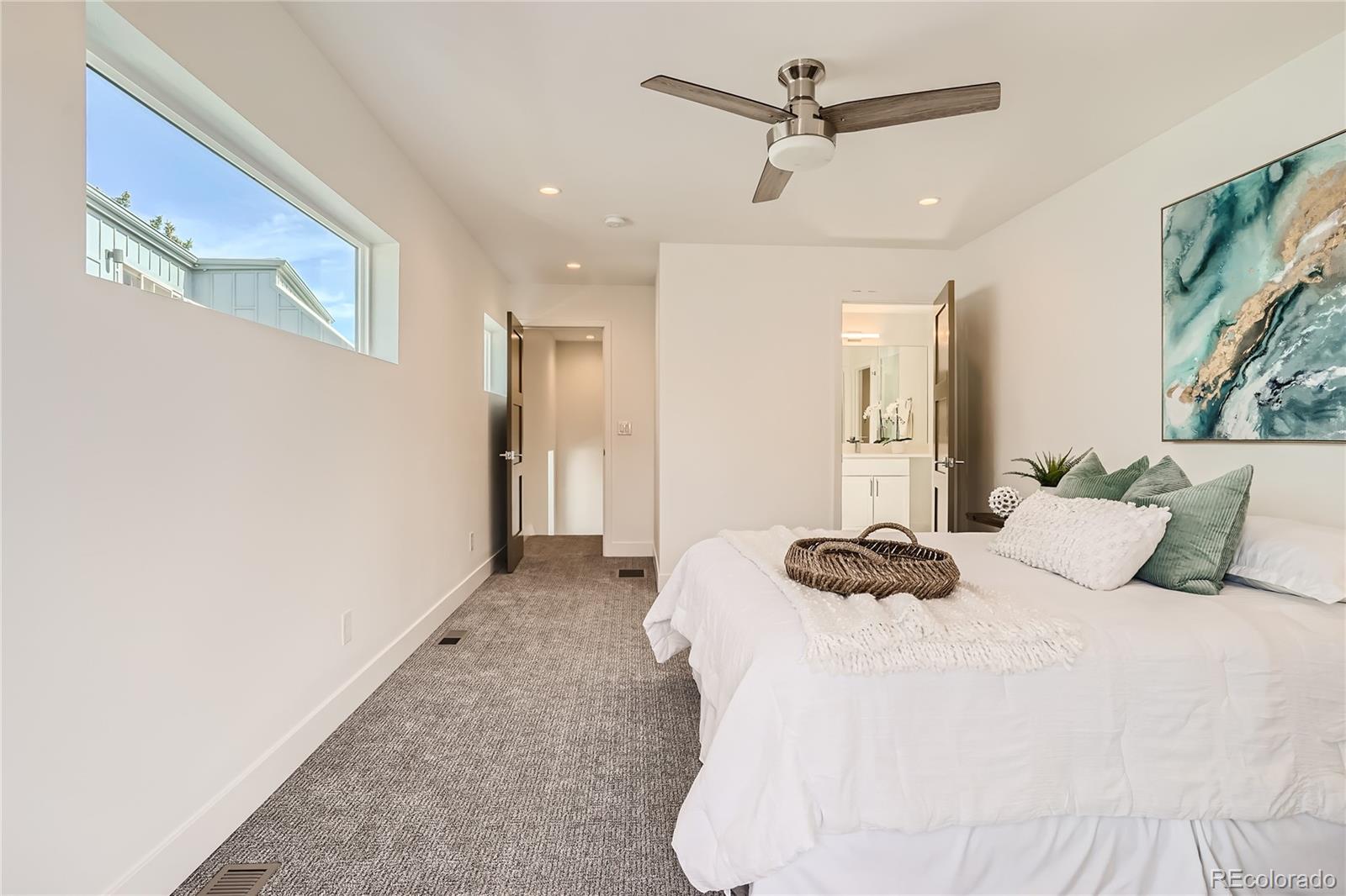 1255 Perry Street Denver, CO 80204 - Photo 18 of 28 a bedroom with a bed and a chandelier