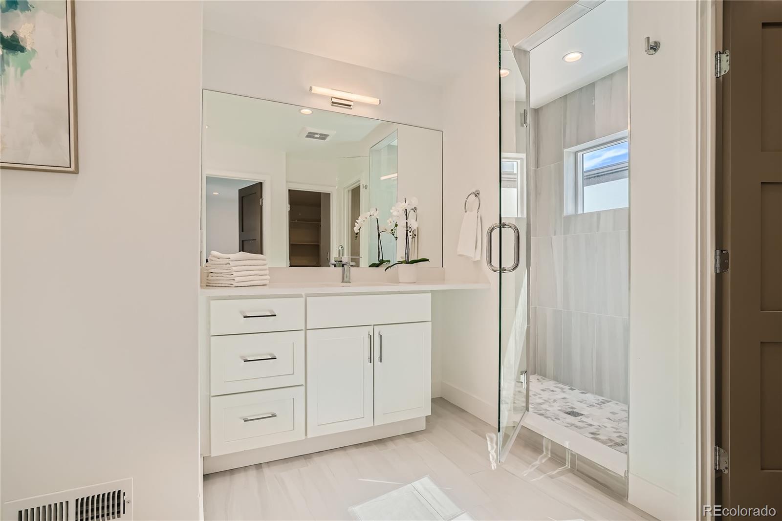 1255 Perry Street Denver, CO 80204 - Photo 19 of 28 a bathroom with a double vanity sink mirror and shower