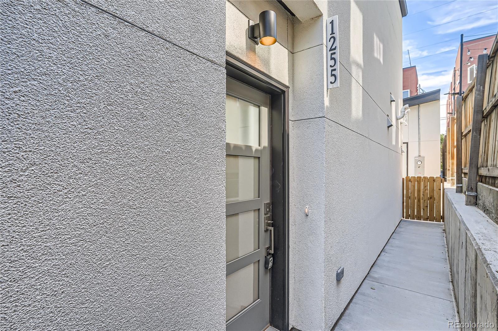 1255 Perry Street Denver, CO 80204 - Photo 3 of 28 a view of a brick house with a street