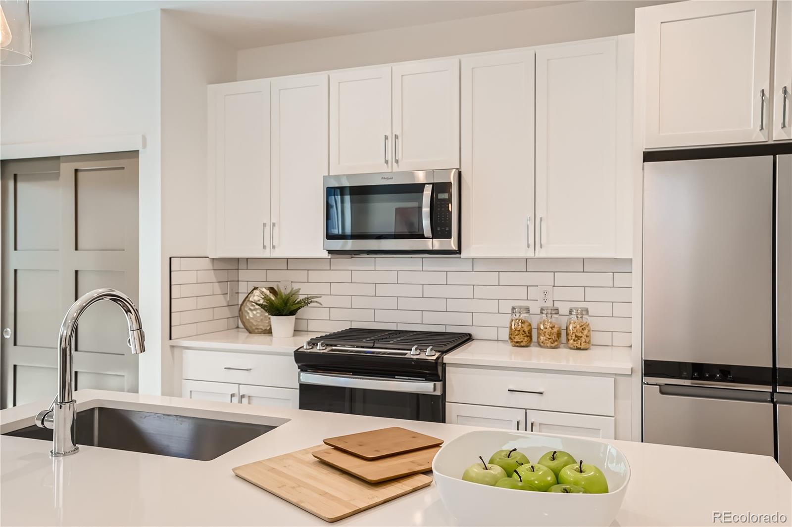 1255 Perry Street Denver, CO 80204 - Photo 6 of 28 a kitchen with appliances a sink and cabinets