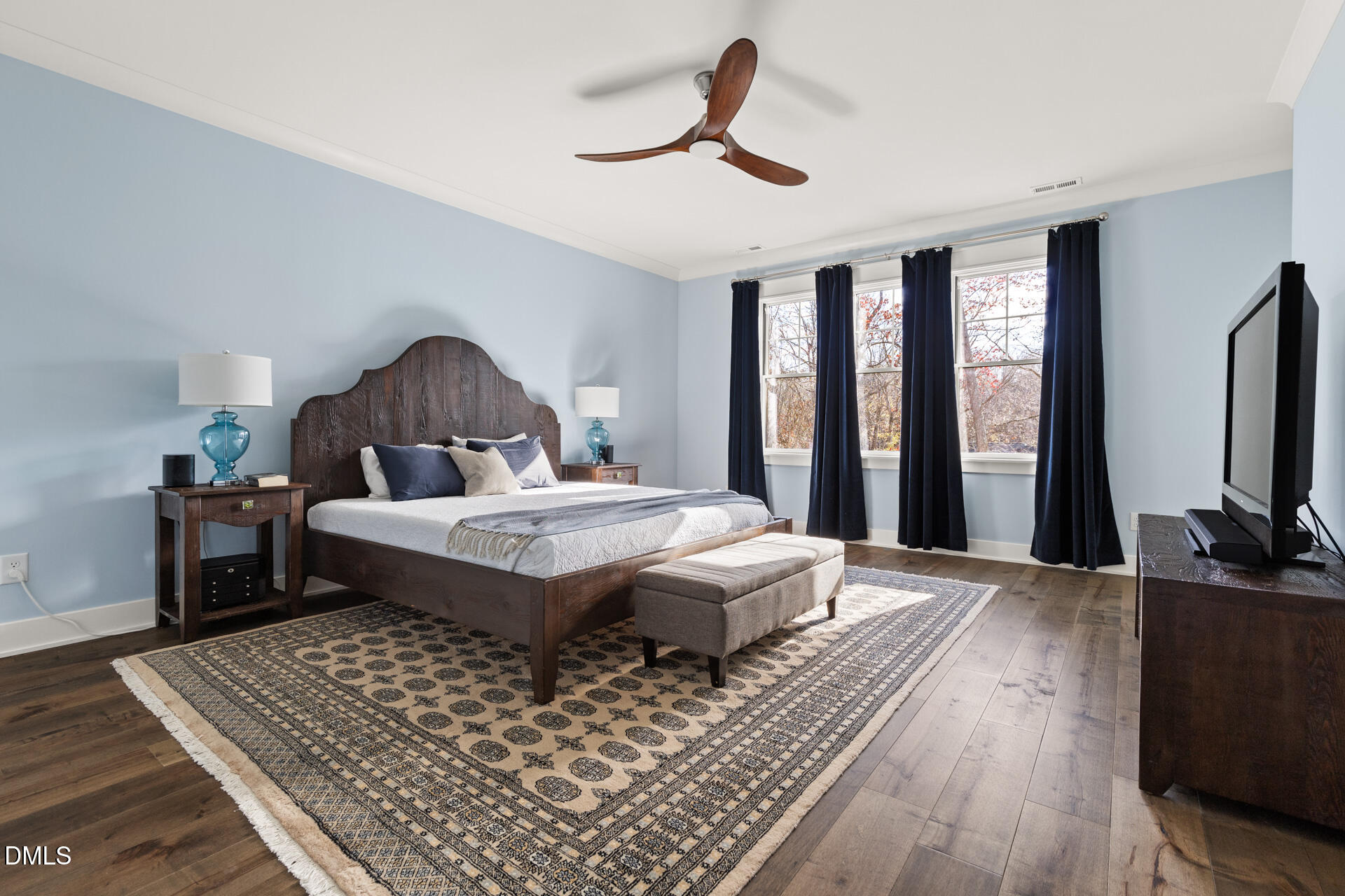 3025 Eden Harbor Court Raleigh, NC 27613 - Photo 22 of 41 a bedroom with a bed a flat screen tv and a large window
