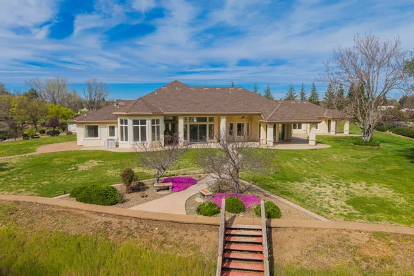 a front view of a house with garden