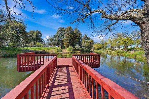 a view of balcony with wooden floor and lake view