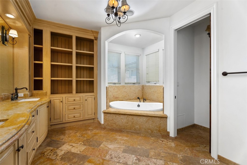 26509 Via Sacramento Dana Point, CA 92624 - Photo 28 of 52 a bathroom with a granite countertop sink a bathtub and a tub