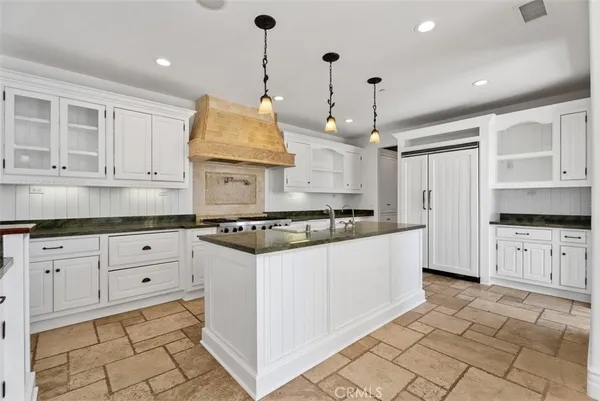 a stove top oven sitting inside of a kitchen