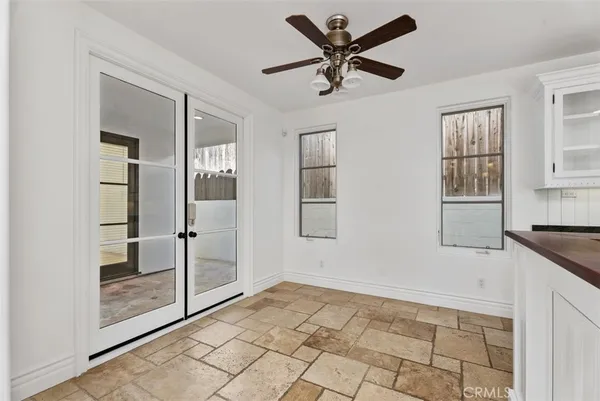 a kitchen with granite countertop white cabinets and a sink