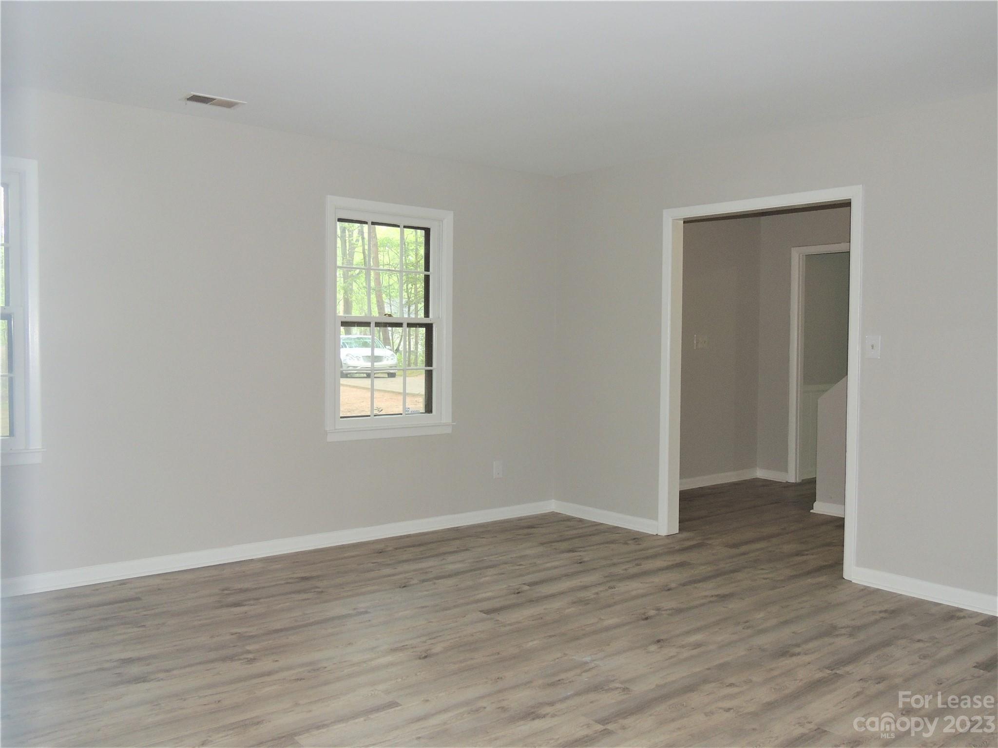 8700 Houston Ridge Road Charlotte, NC 28277 - Photo 11 of 29 a view of an empty room with wooden floor and a window