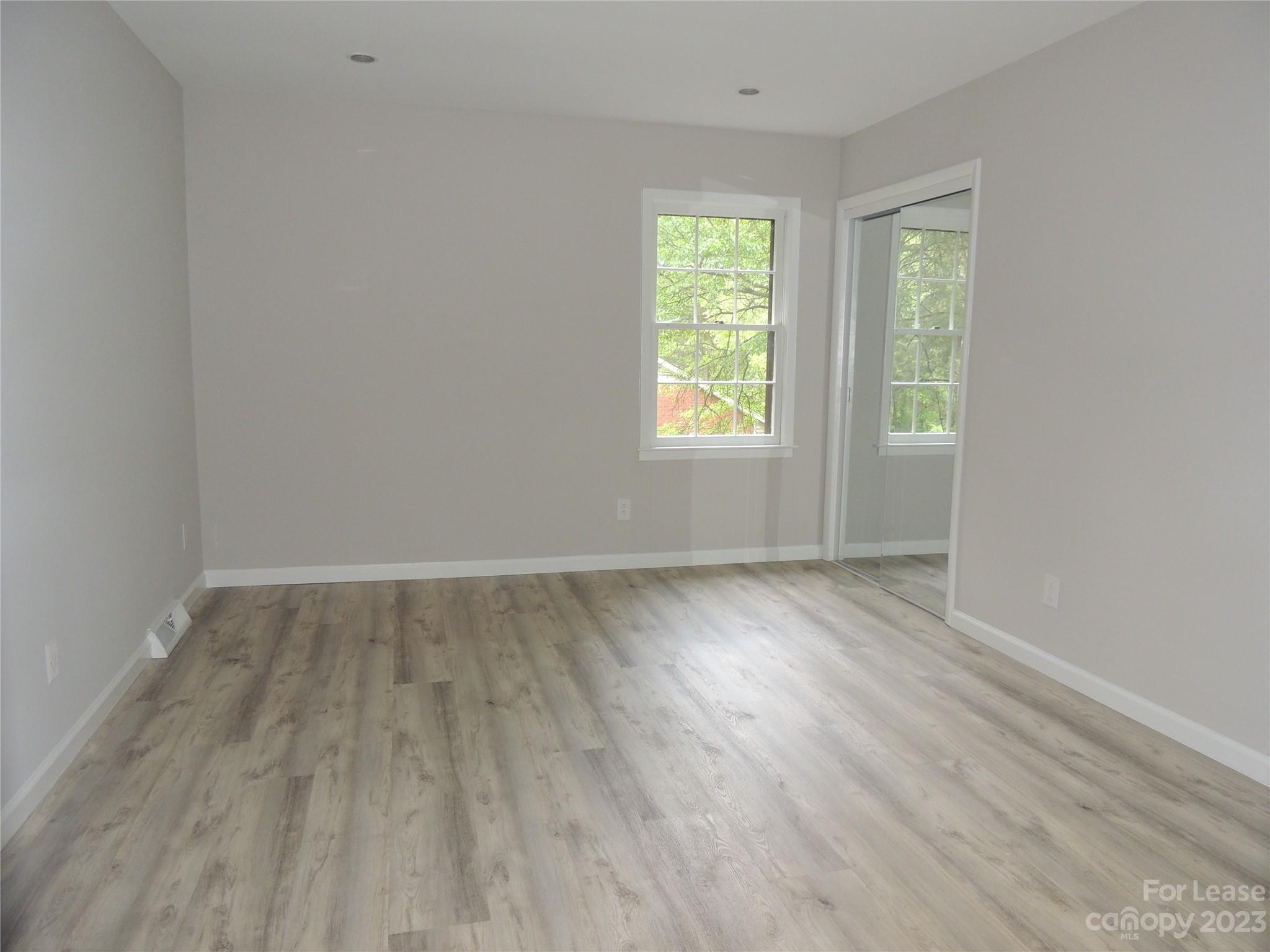 8700 Houston Ridge Road Charlotte, NC 28277 - Photo 12 of 29 an empty room with wooden floor and windows