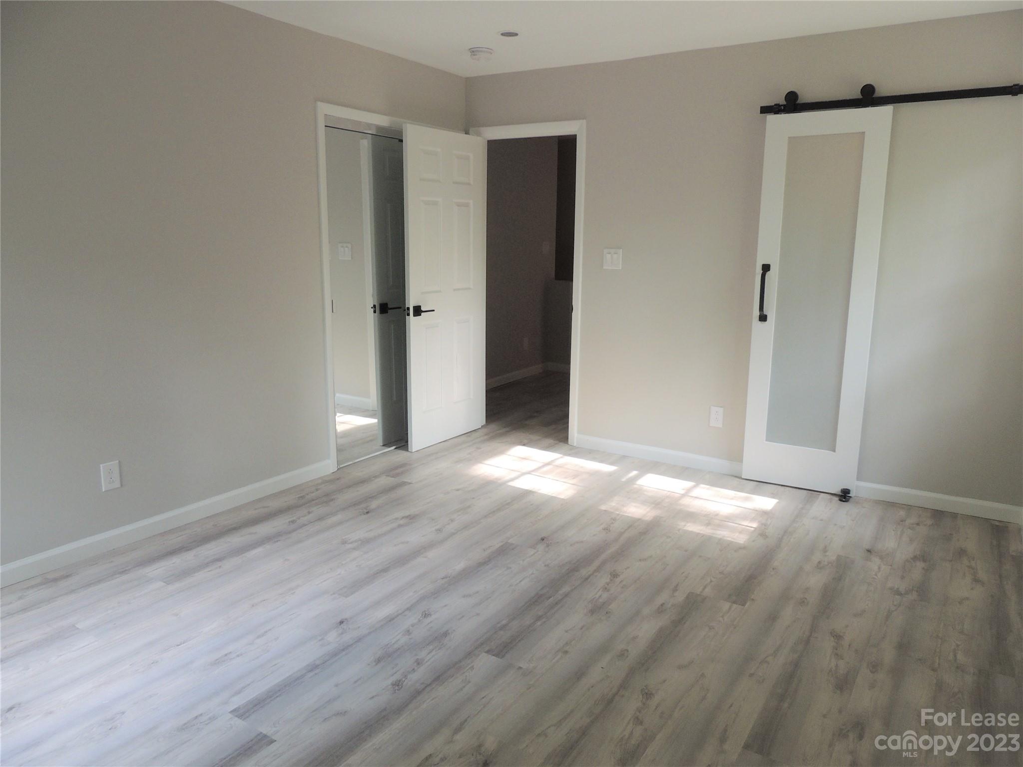 8700 Houston Ridge Road Charlotte, NC 28277 - Photo 13 of 29 a view of an empty room with wooden floor and a window