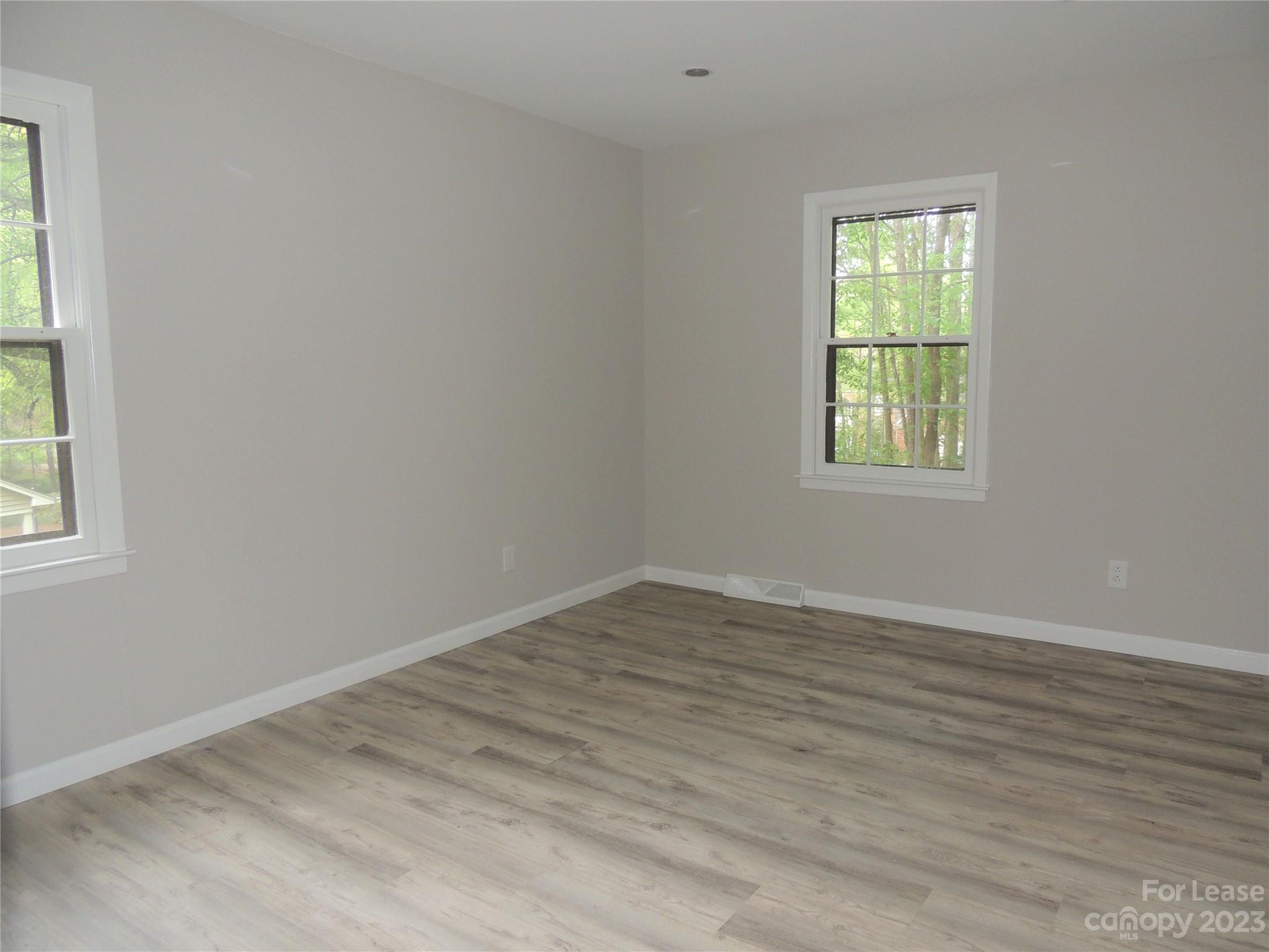 8700 Houston Ridge Road Charlotte, NC 28277 - Photo 17 of 29 an empty room with wooden floor and windows
