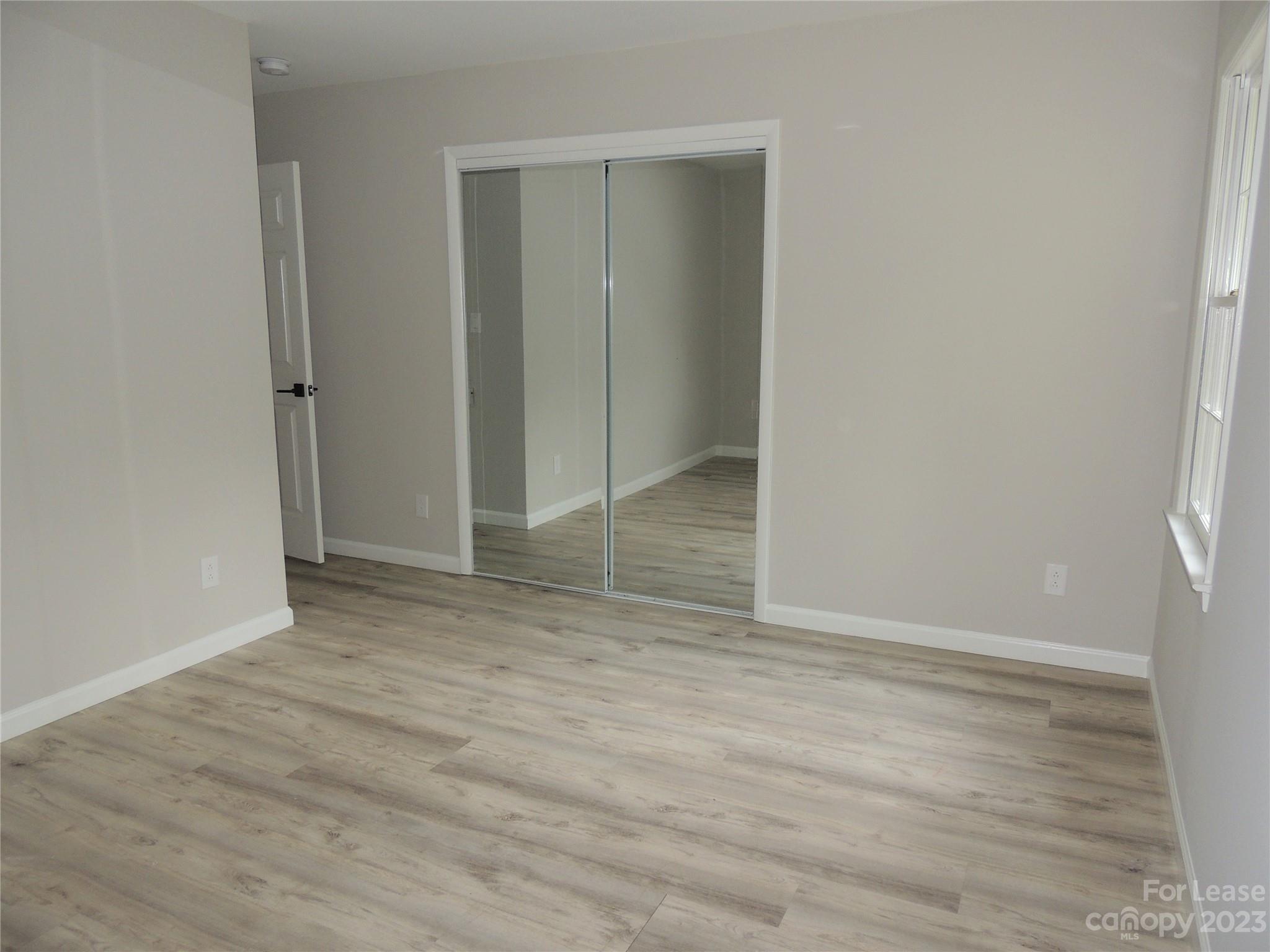 8700 Houston Ridge Road Charlotte, NC 28277 - Photo 18 of 29 an empty room with wooden floor and closet