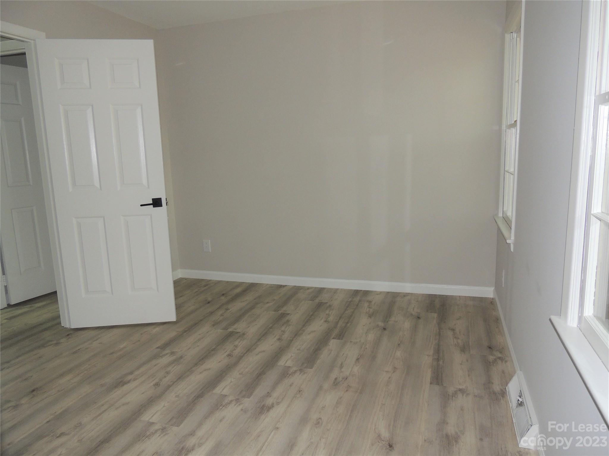 8700 Houston Ridge Road Charlotte, NC 28277 - Photo 19 of 29 a view of an empty room with wooden floor and a window