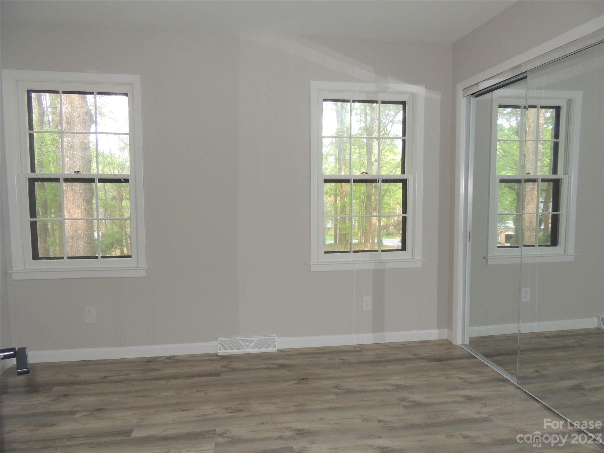 8700 Houston Ridge Road Charlotte, NC 28277 - Photo 20 of 29 a view of an empty room with wooden floor and windows