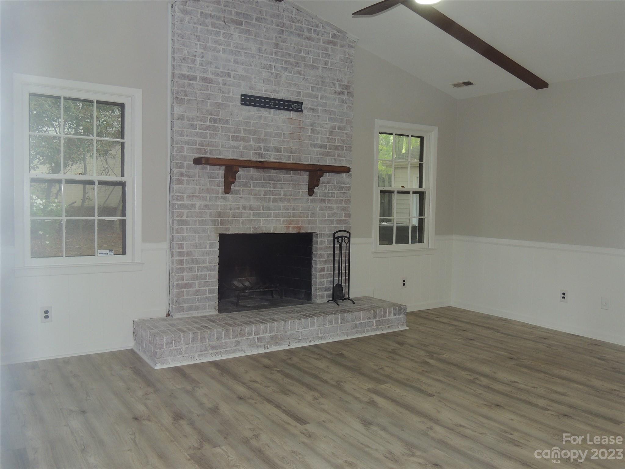 8700 Houston Ridge Road Charlotte, NC 28277 - Photo 4 of 29 a view of empty room with wooden floor and fireplace