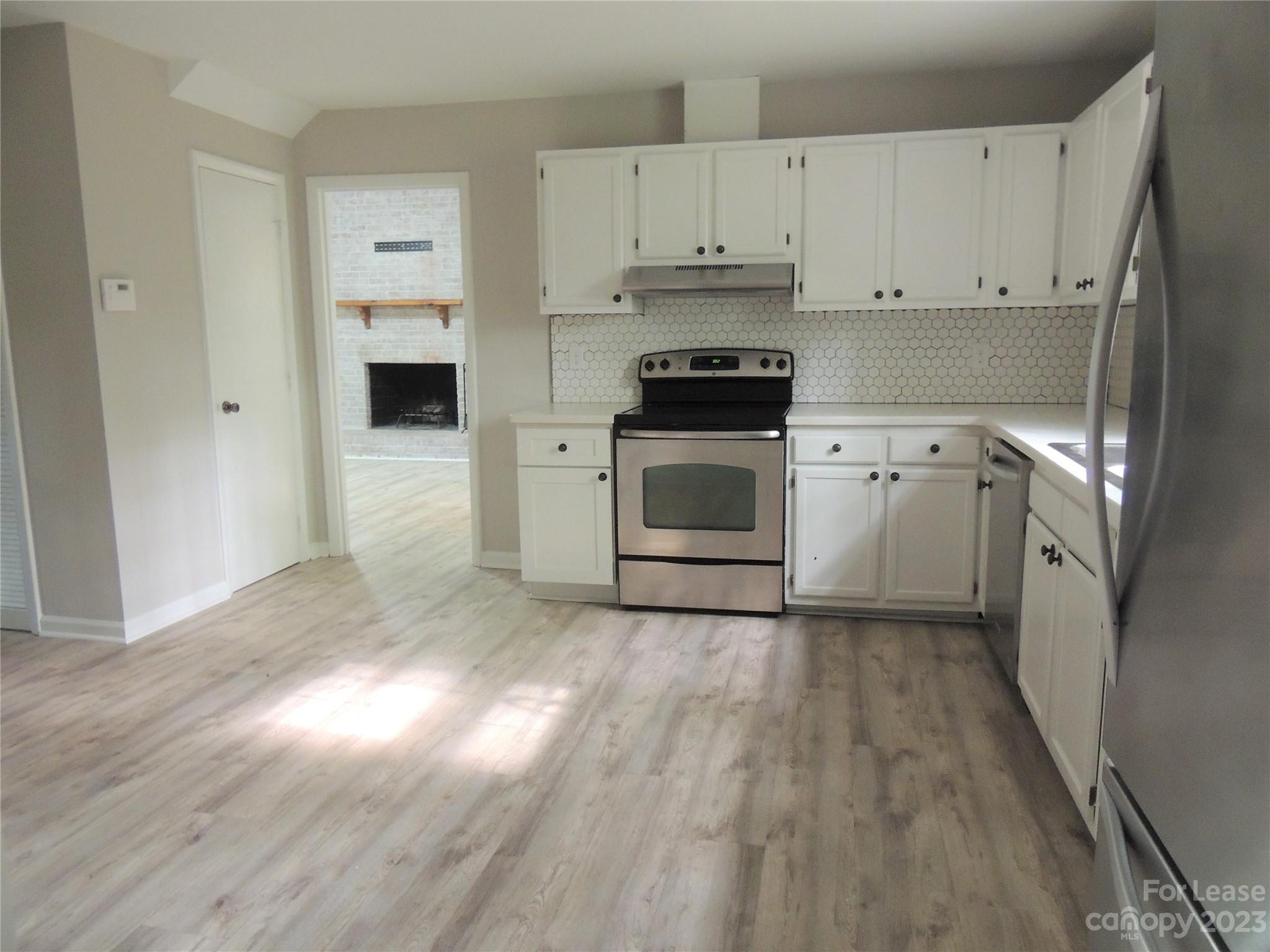 8700 Houston Ridge Road Charlotte, NC 28277 - Photo 8 of 29 a kitchen with cabinets stainless steel appliances and wooden floor