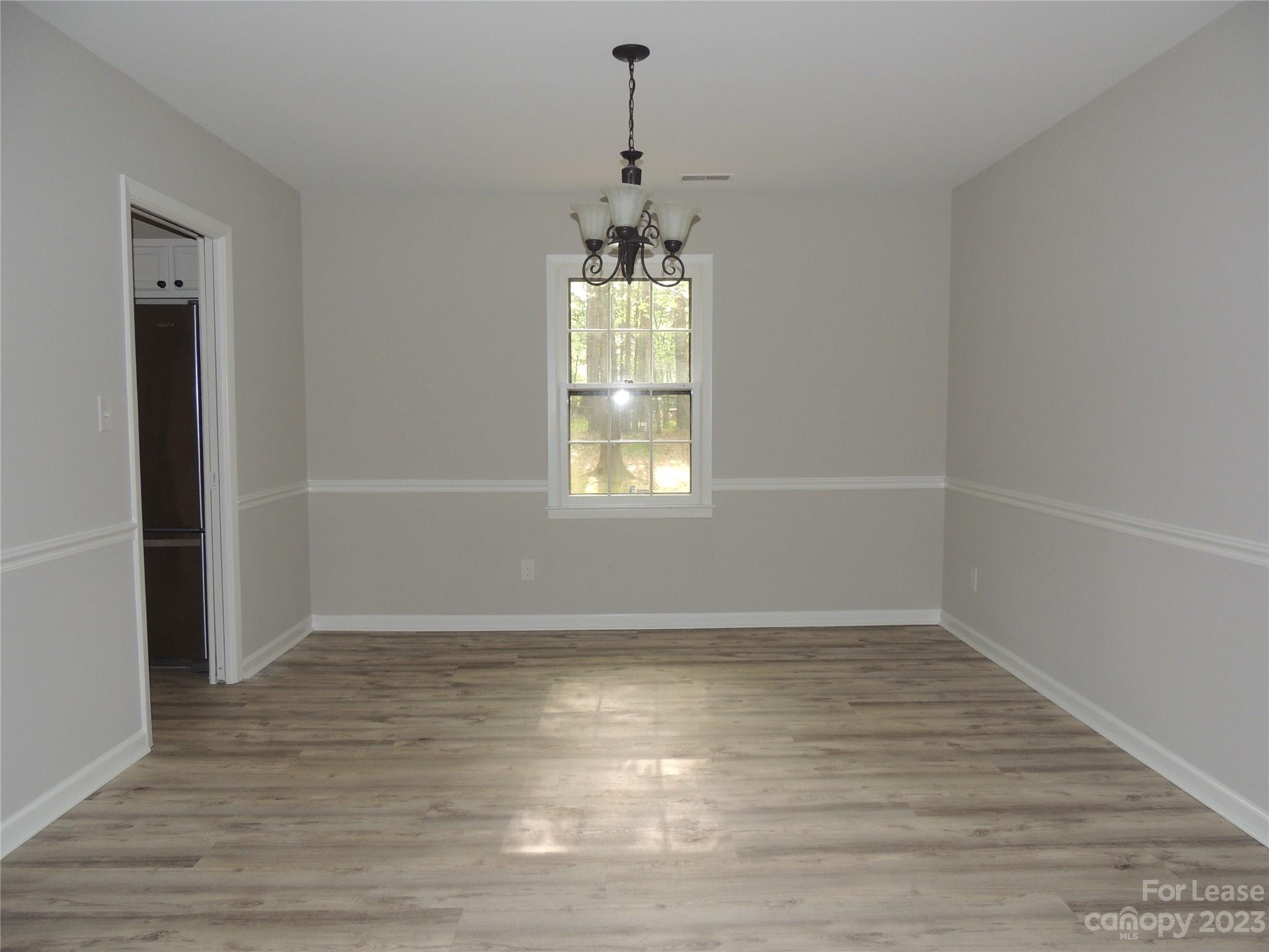 8700 Houston Ridge Road Charlotte, NC 28277 - Photo 9 of 29 an empty room with wooden floor and windows