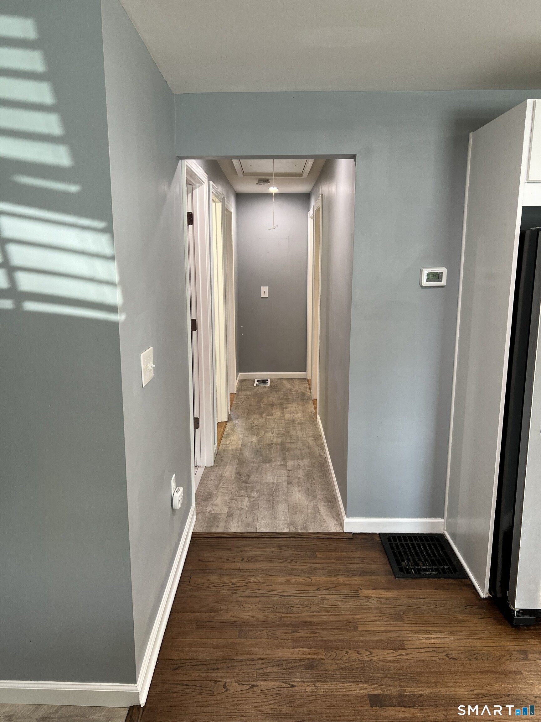 82 Bingham Street Bristol, CT 06010 - Photo 12 of 40 a view of a hallway with wooden floor and closet