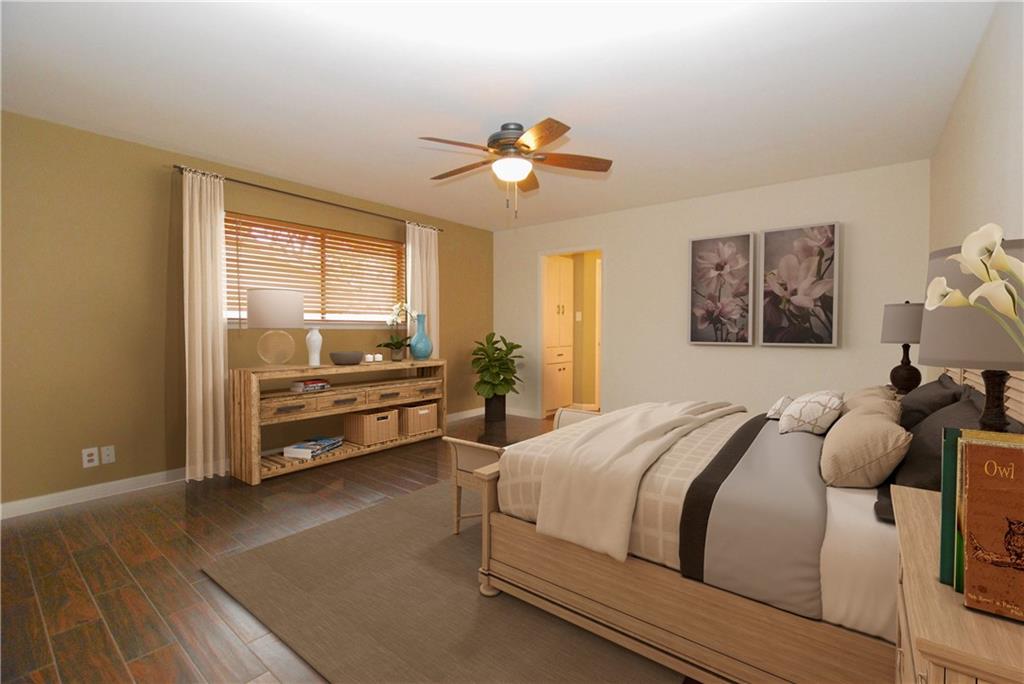 11724 Running Fox Trail Austin, TX 78759 - Photo 11 of 18 a bedroom with a bed and a chandelier