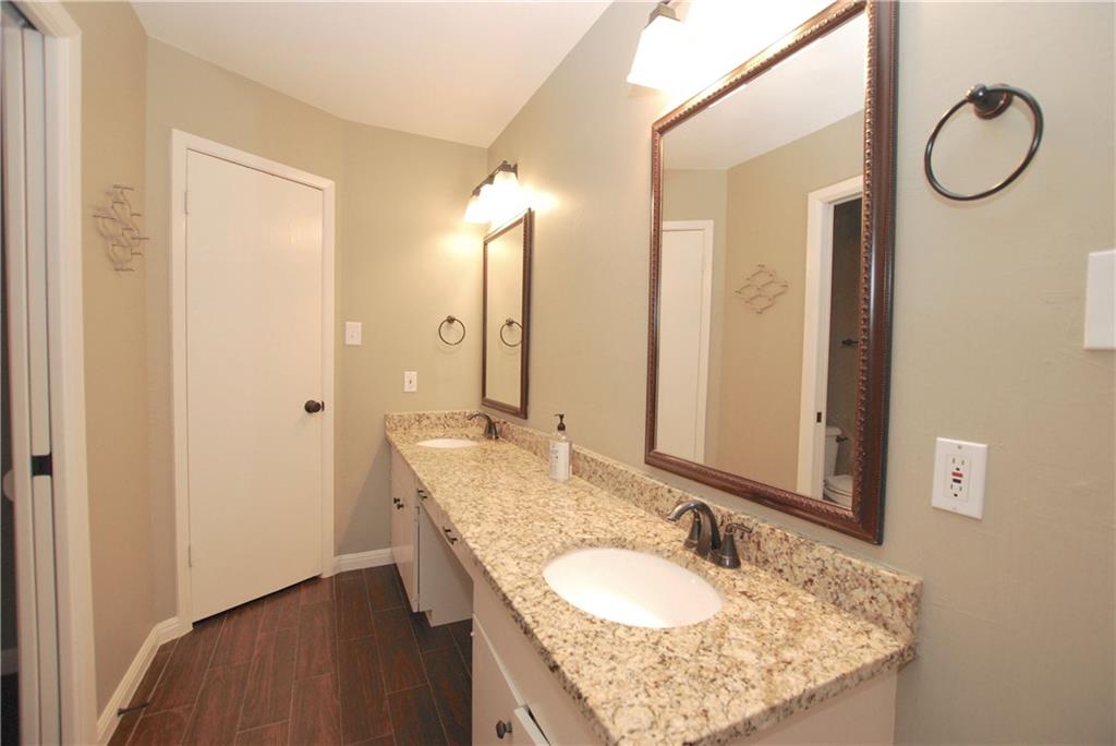 11724 Running Fox Trail Austin, TX 78759 - Photo 13 of 18 a bathroom with a granite countertop double vanity sink and a mirror
