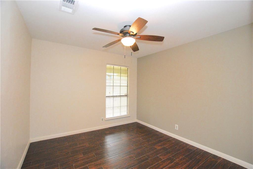 11724 Running Fox Trail Austin, TX 78759 - Photo 14 of 18 an empty room with wooden floor fan and windows