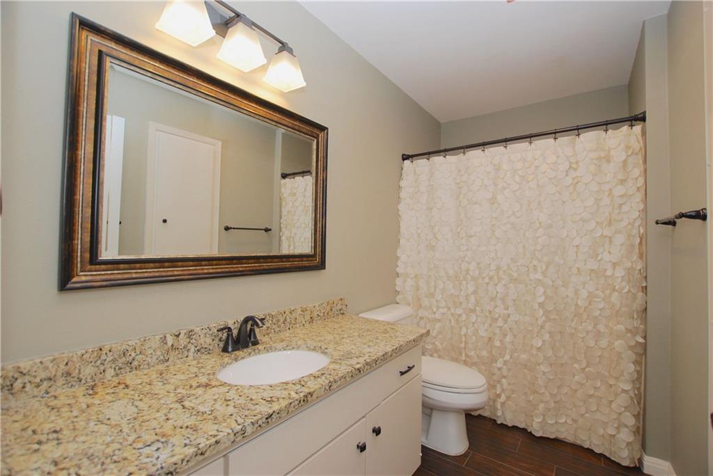11724 Running Fox Trail Austin, TX 78759 - Photo 15 of 18 a bathroom with a granite countertop sink toilet and mirror