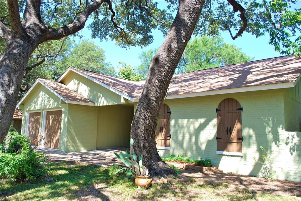 11724 Running Fox Trail Austin, TX 78759 - Photo 2 of 18 a front view of a house with garden
