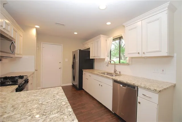 a kitchen with a sink stove and refrigerator