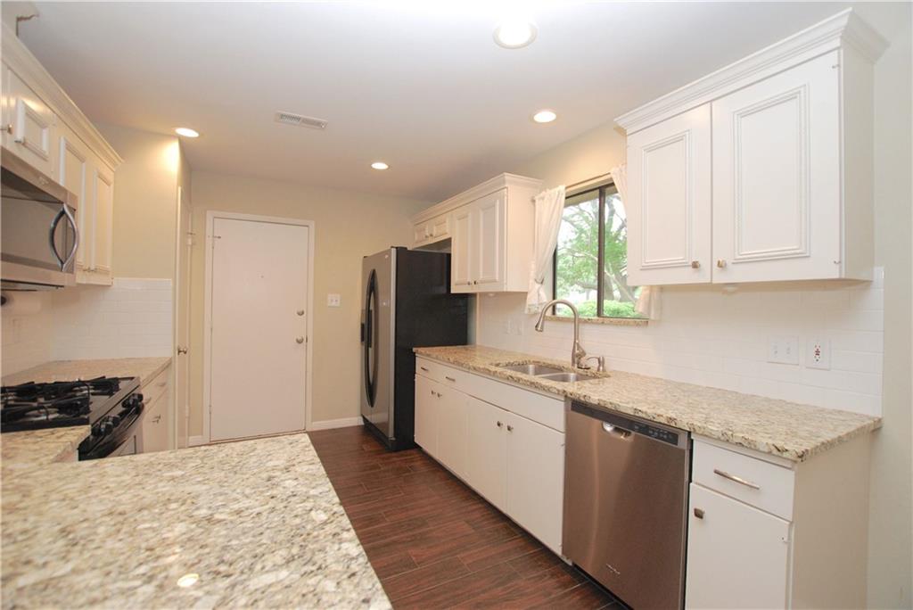 11724 Running Fox Trail Austin, TX 78759 - Photo 6 of 18 a kitchen with a sink stove and refrigerator