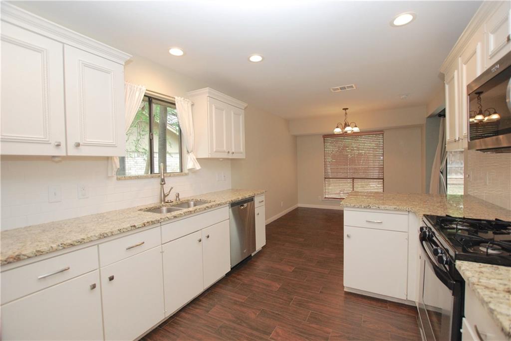 11724 Running Fox Trail Austin, TX 78759 - Photo 8 of 18 a kitchen with a sink stove and cabinets
