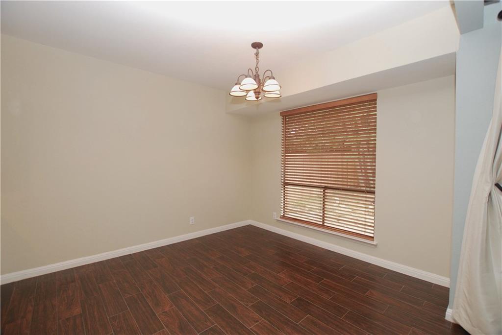 11724 Running Fox Trail Austin, TX 78759 - Photo 10 of 18 wooden floor in an empty room with a window