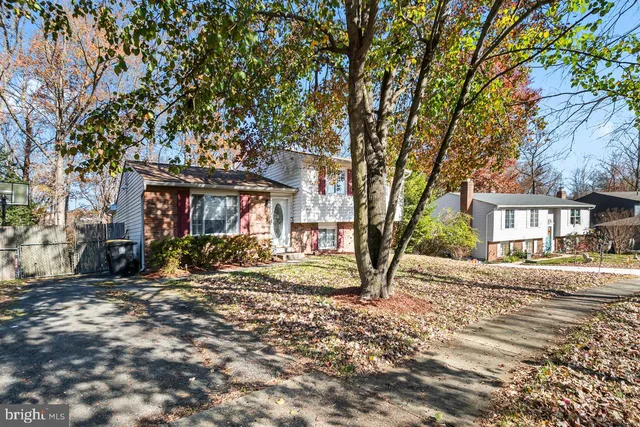 a view of a house with a yard covered in snow