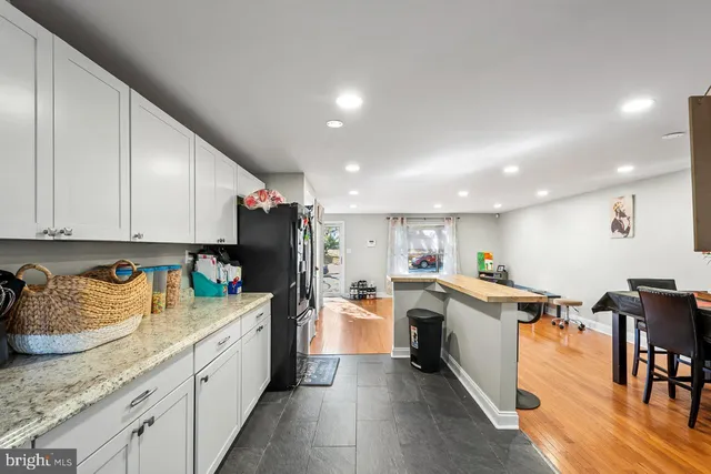 a kitchen with stainless steel appliances granite countertop a refrigerator sink and cabinets