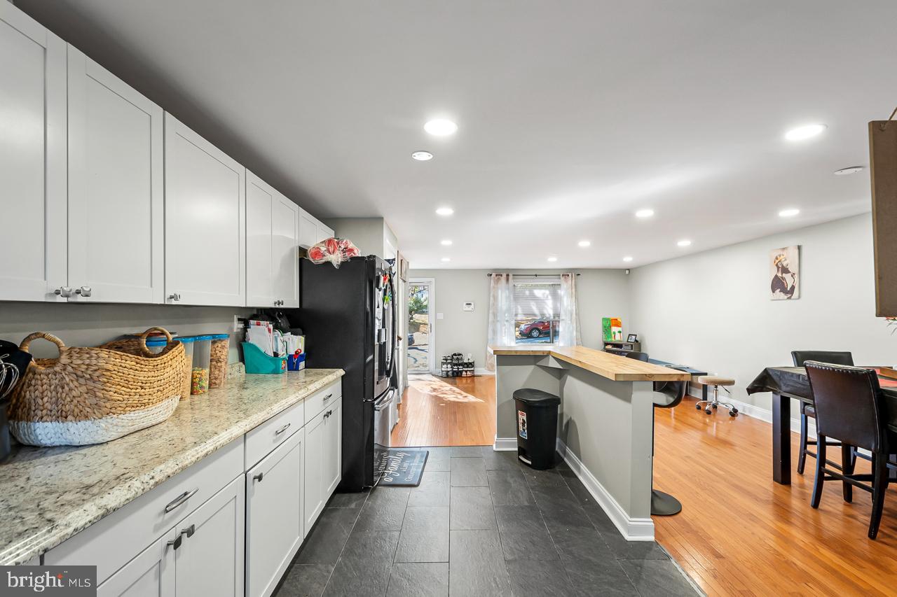 7002 Killarney Street Clinton, MD 20735 - Photo 12 of 26 a kitchen with stainless steel appliances granite countertop a refrigerator sink and cabinets