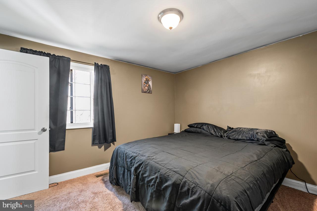 7002 Killarney Street Clinton, MD 20735 - Photo 15 of 26 a bedroom with a bed and a window