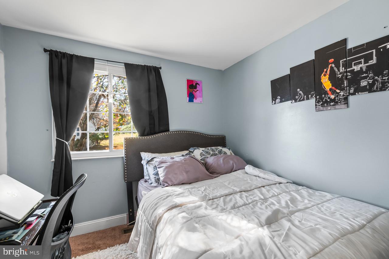 7002 Killarney Street Clinton, MD 20735 - Photo 19 of 26 a bedroom with a bed and a window