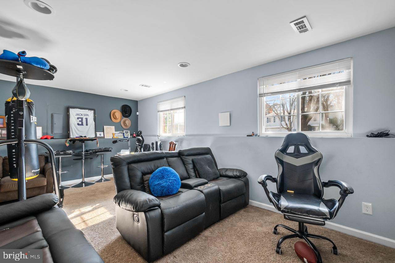 7002 Killarney Street Clinton, MD 20735 - Photo 21 of 26 a living room with furniture a chandelier and a large window