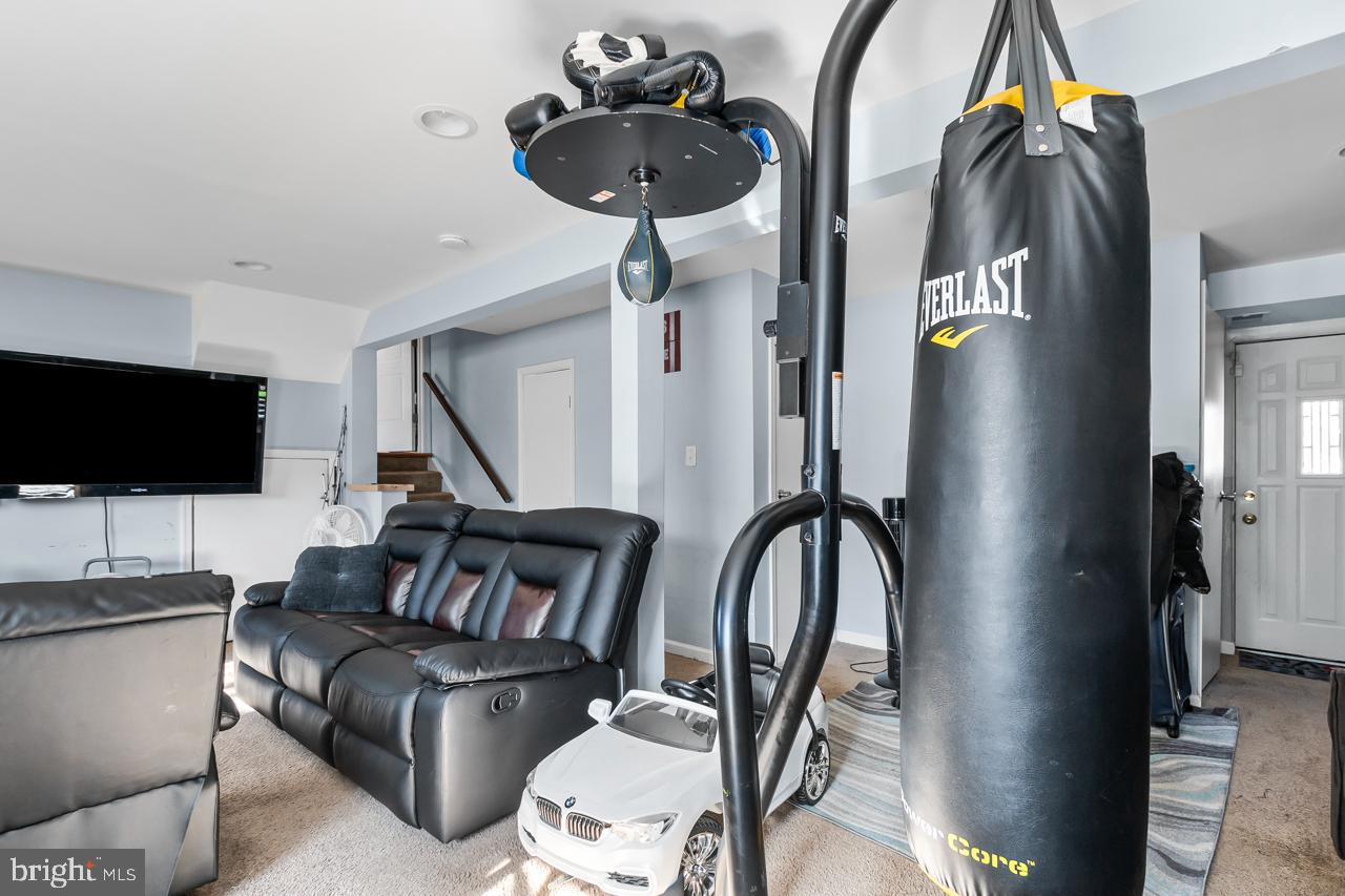 7002 Killarney Street Clinton, MD 20735 - Photo 22 of 26 a living room with furniture and a flat screen tv