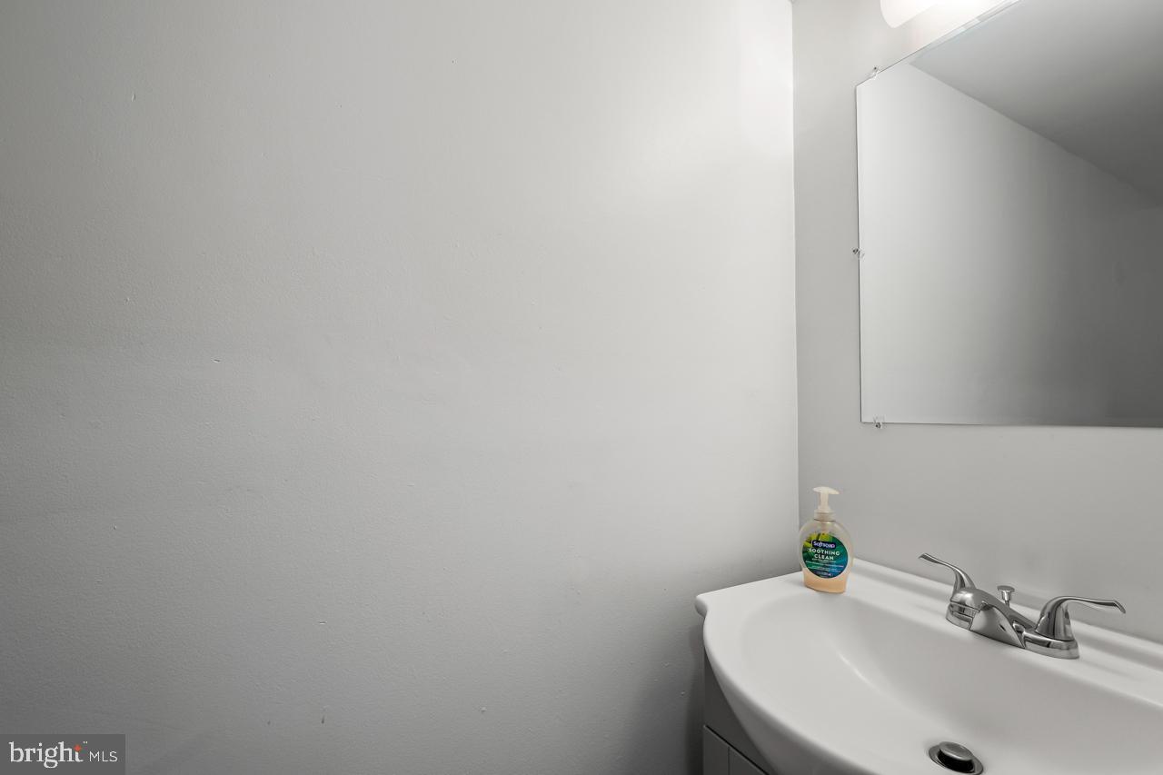 7002 Killarney Street Clinton, MD 20735 - Photo 23 of 26 a bathroom with a sink and a mirror