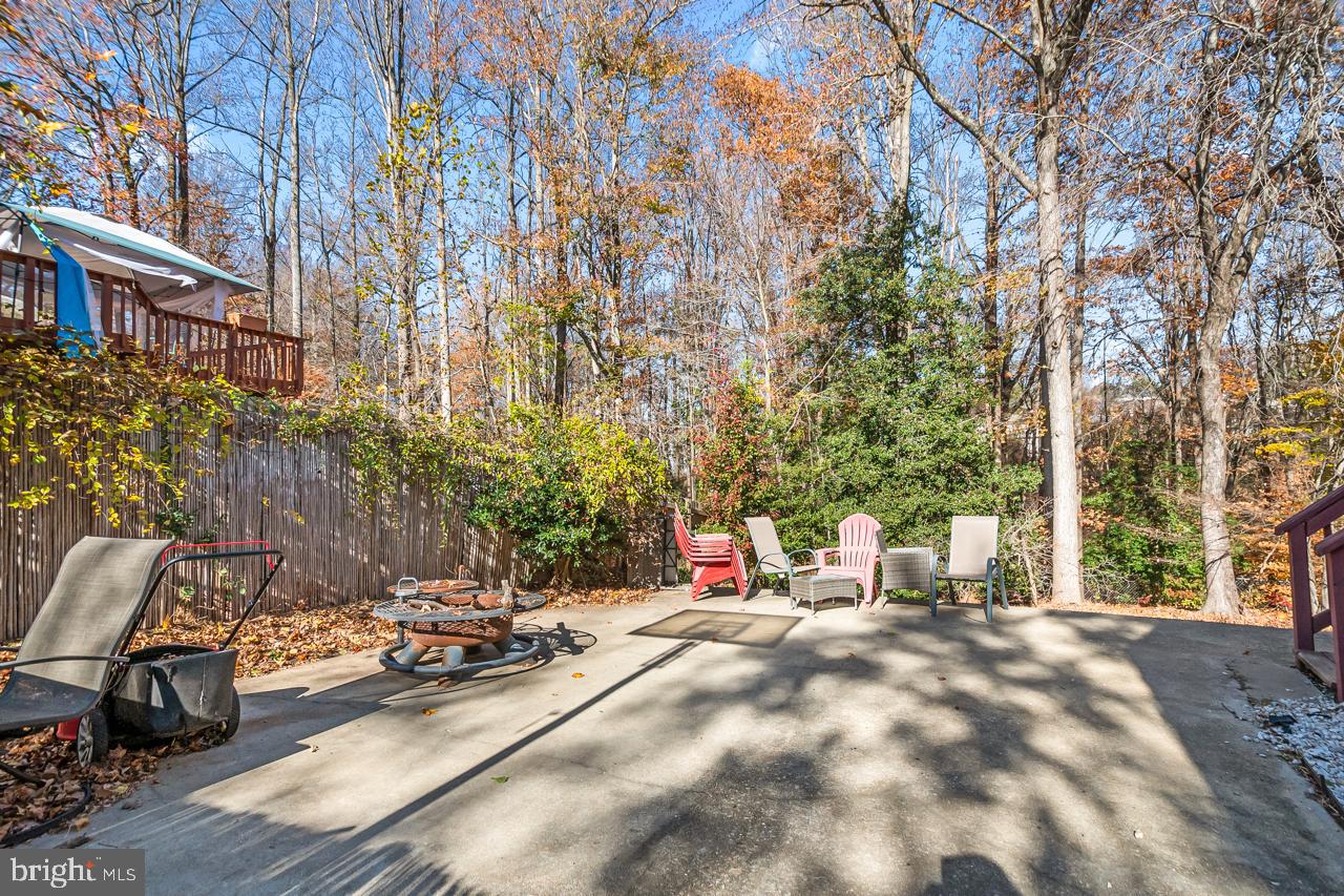 7002 Killarney Street Clinton, MD 20735 - Photo 24 of 26 a view of backyard with a table and chairs and a large tree