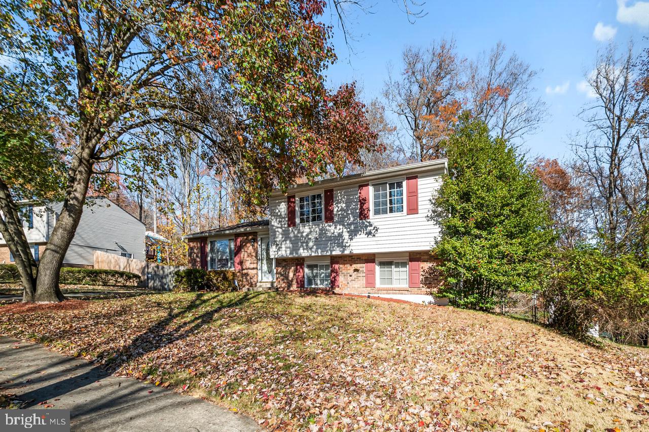 7002 Killarney Street Clinton, MD 20735 - Photo 3 of 26 a view of a house with a yard and tree s