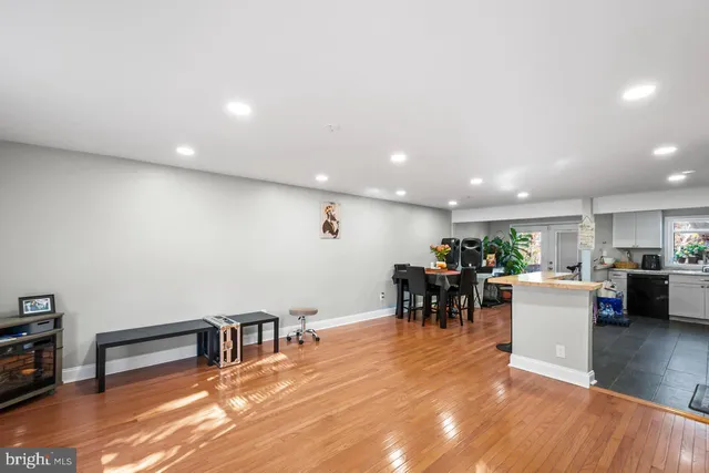 a living room with furniture and a dining table with kitchen view